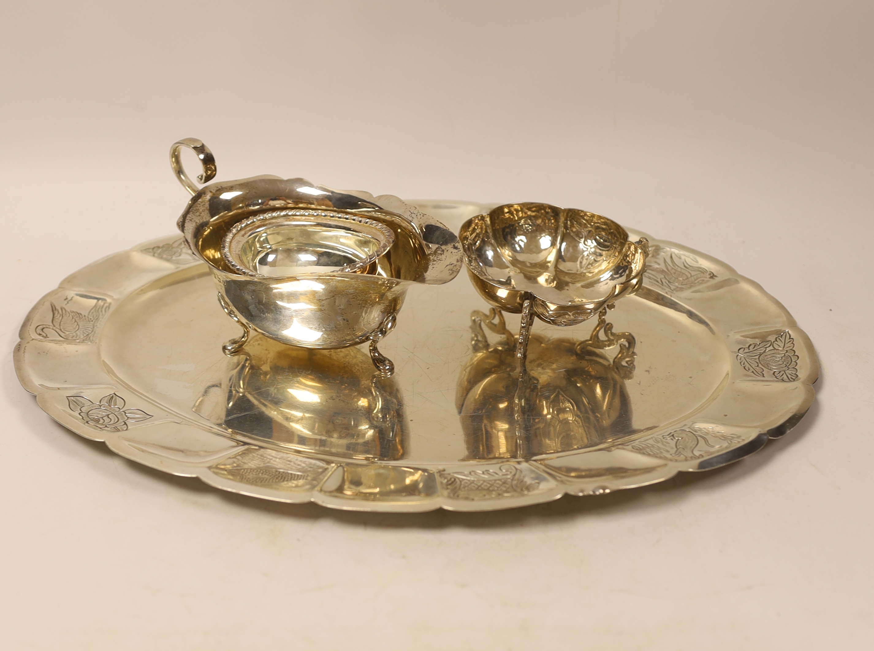 A Mexican sterling oval tray, 40.1cm, a similar bowl on tripod supports, a modern silver sauce boat and oval silver salt, 32.7oz.